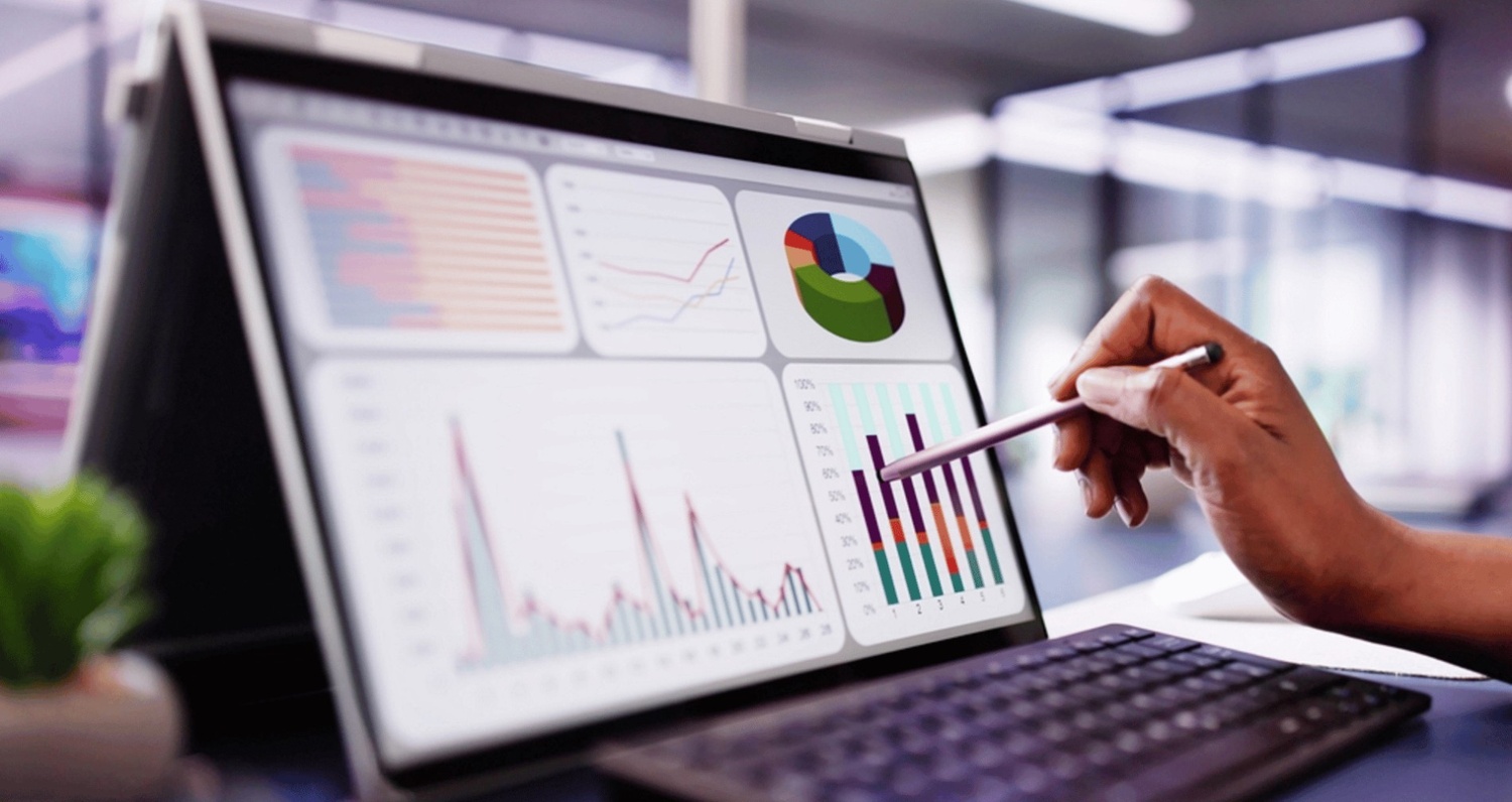 This image focuses on the final and most critical stage of any marketing campaign: Data Analysis. It shows a professional using a stylus to interact with a complex dashboard of charts and graphs on a laptop.