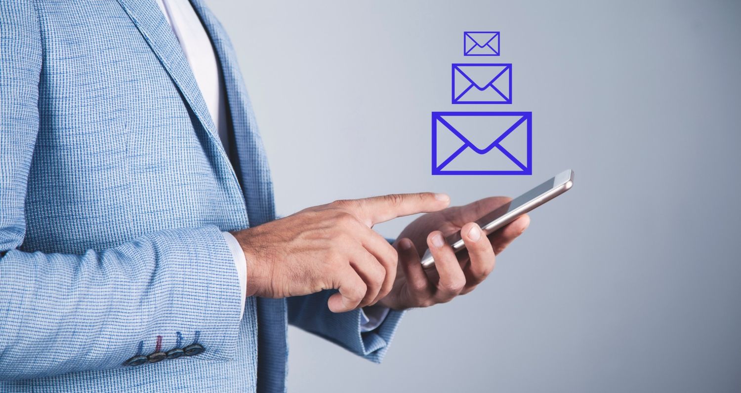 A person wearing a light blue suit holding and interacting with a smartphone, with three stylized blue envelope icons floating vertically above the device, representing digital messaging and communication.
