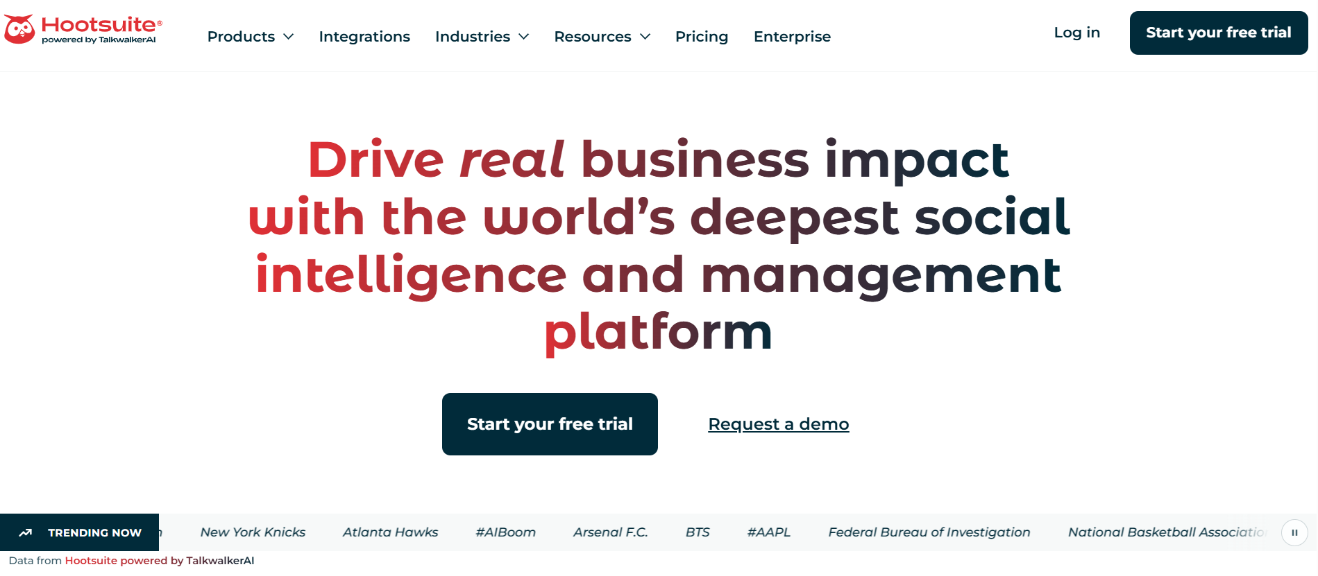The image displays the homepage of the Hootsuite website, featuring a bold headline promoting their social intelligence and management platform using a stylized red-to-blue text gradient. Below the main messaging, there are prominent call-to-action buttons for starting a free trial or requesting a demo, along with a scrolling 