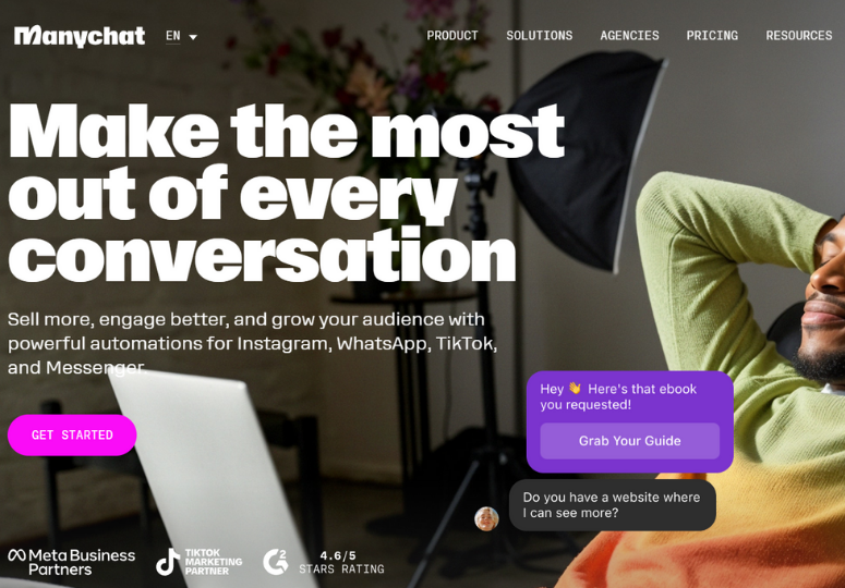 ManyChat website homepage with the headline “Make the most out of every conversation.” The page promotes automation for Instagram, WhatsApp, TikTok, and Messenger, with a “Get Started” button. A chat preview shows a message offering an ebook download, while a person relaxes beside a laptop in the background.