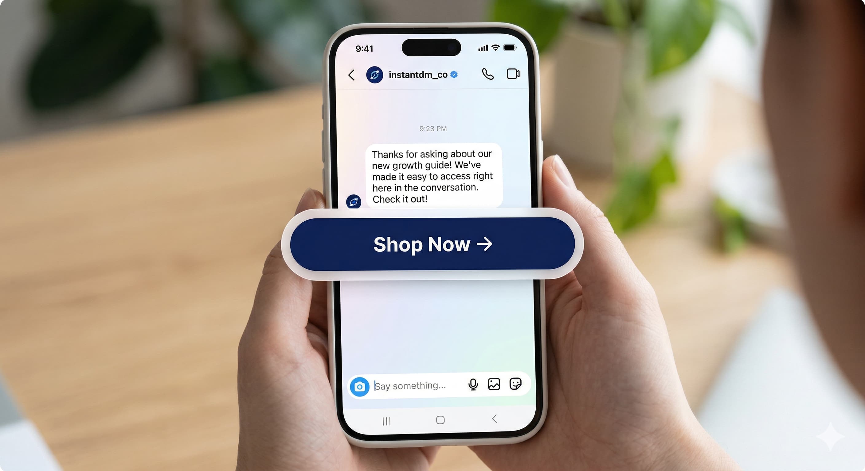 Close-up of a person holding a smartphone displaying a professional Instagram Direct Message from InstantDM. The screen shows a native-style "Shop Now" call-to-action button, illustrating automated sales funnel technology for 2026.