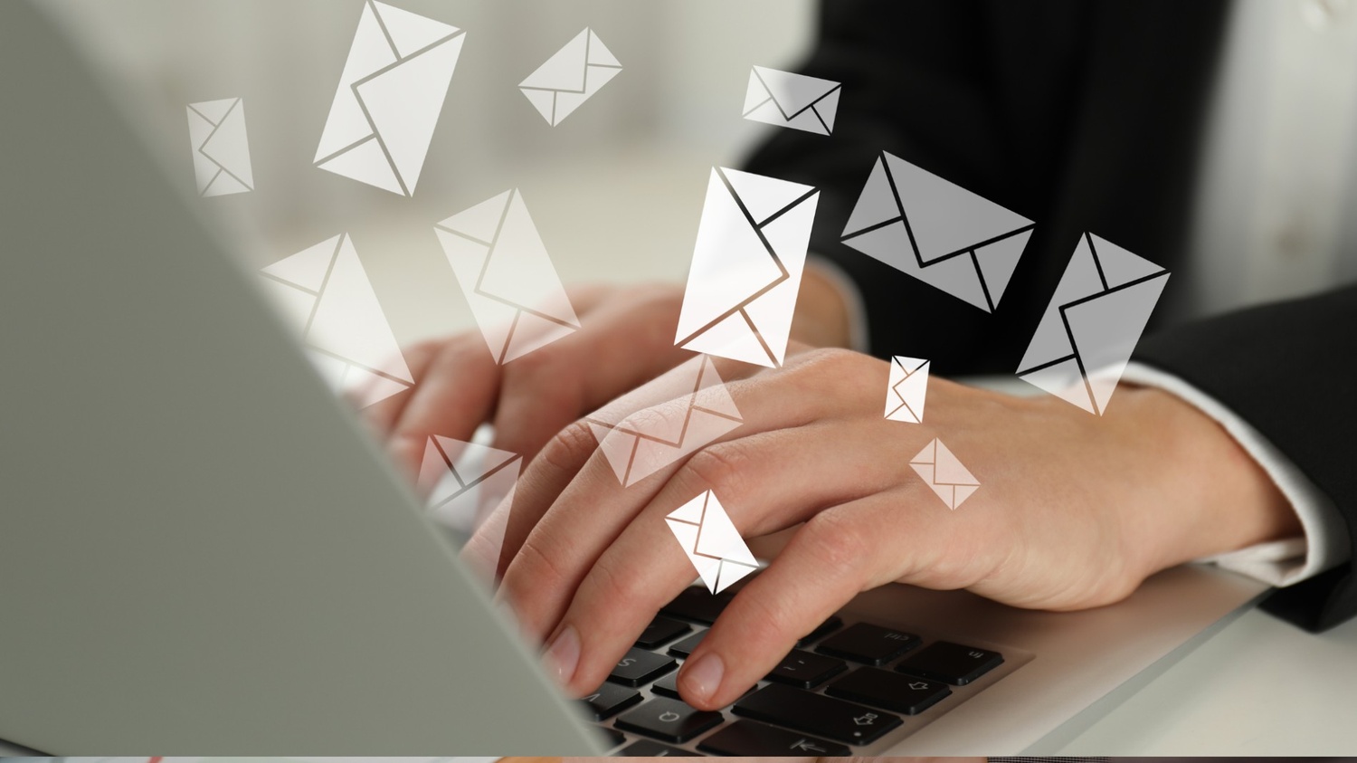 A close-up of a person's hands typing on a laptop keyboard, with several digital envelope icons floating above the keys, symbolizing the recovery of abandoned carts through automated messaging.