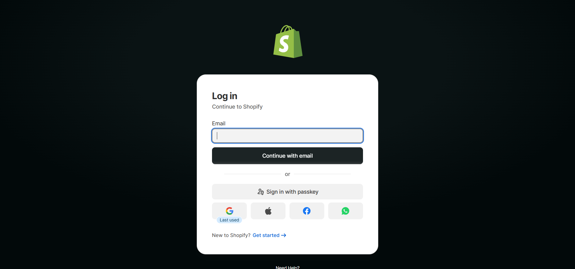 Shopify login page showing an email field, “Continue with email” button, passkey sign-in, and Google, Apple, Facebook, and WhatsApp login options.